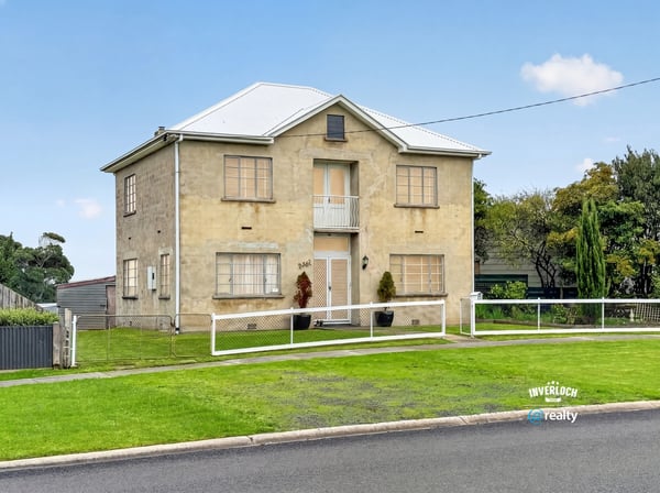 Spacious two-story home featuring ample yard space and unique architectural details in a quiet neighborhood.