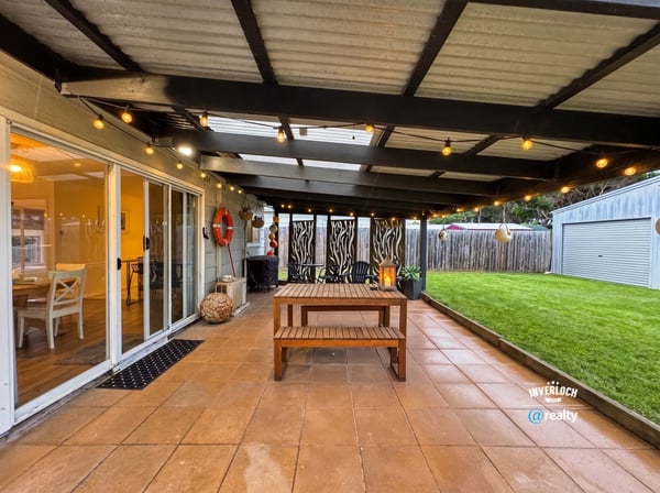 This inviting outdoor space features a spacious patio, perfect for gatherings and relaxation amidst landscaped surroundings.