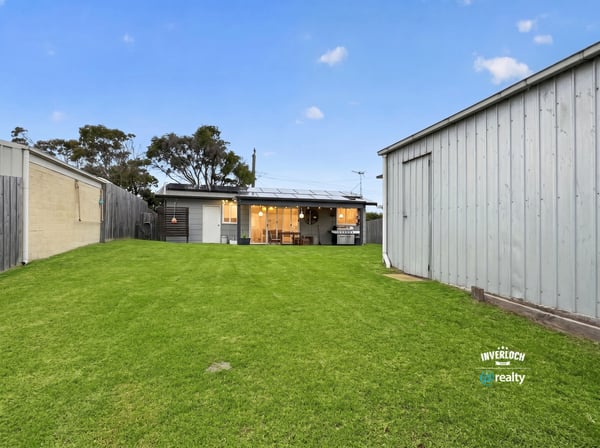 Spacious backyard perfect for outdoor activities, featuring a cozy home with modern amenities and ample storage.