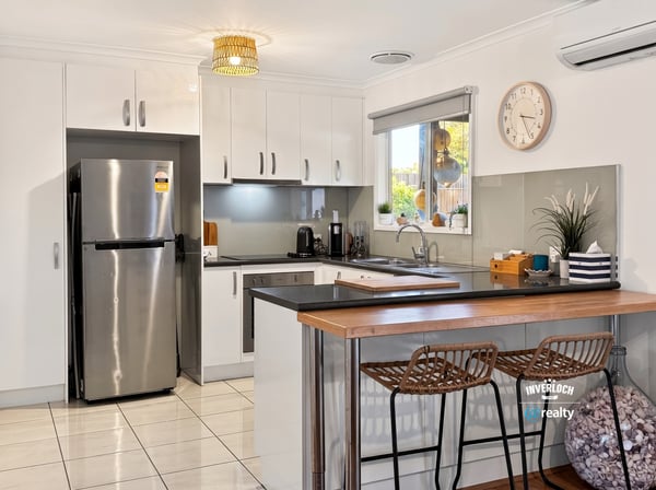 Modern kitchen featuring sleek cabinetry, stainless steel appliances, and a spacious breakfast bar perfect for entertaining.