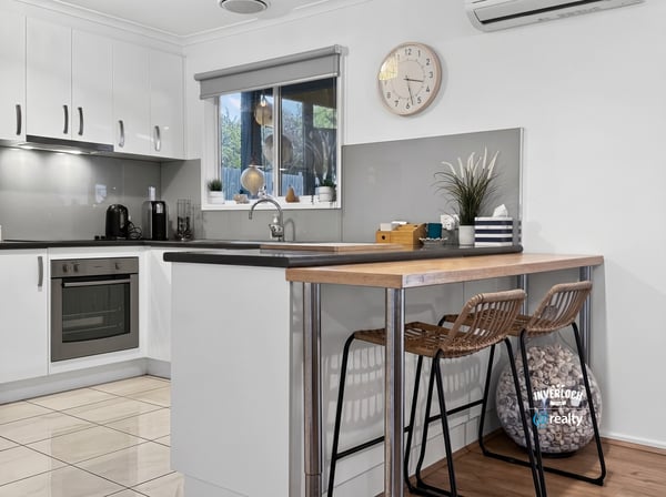 Modern kitchen featuring sleek cabinetry, a cozy breakfast bar, and ample natural light for culinary inspiration.