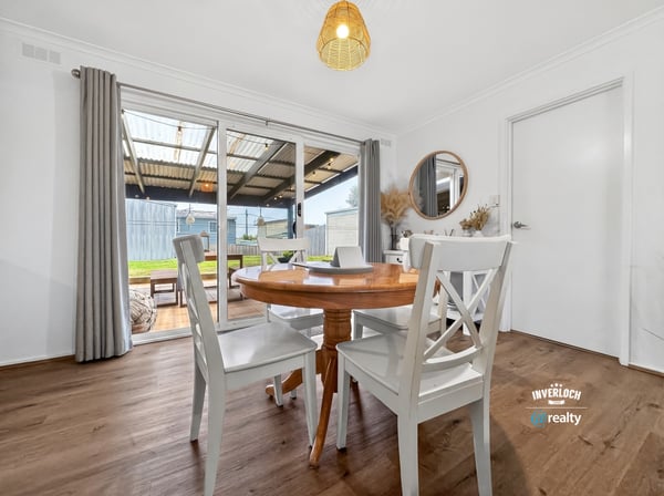 Bright dining area with outdoor access, perfect for enjoying meals and entertaining in a spacious layout.