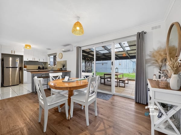 Bright dining area opening to a covered patio, perfect for indoor-outdoor living and entertaining.