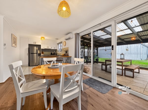 Bright, open-plan dining area seamlessly connects to an outdoor space, perfect for gatherings and relaxation.