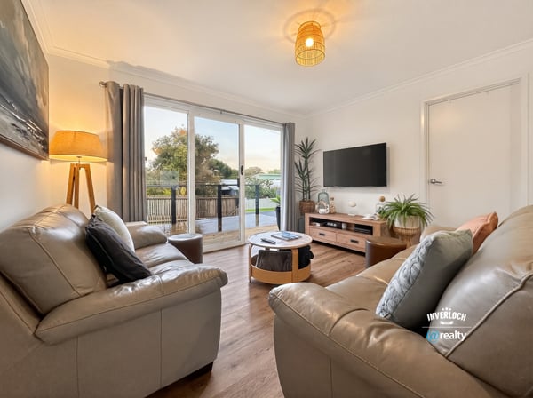 Bright living area features modern furnishings and large sliding doors that open to a scenic outdoor space.
