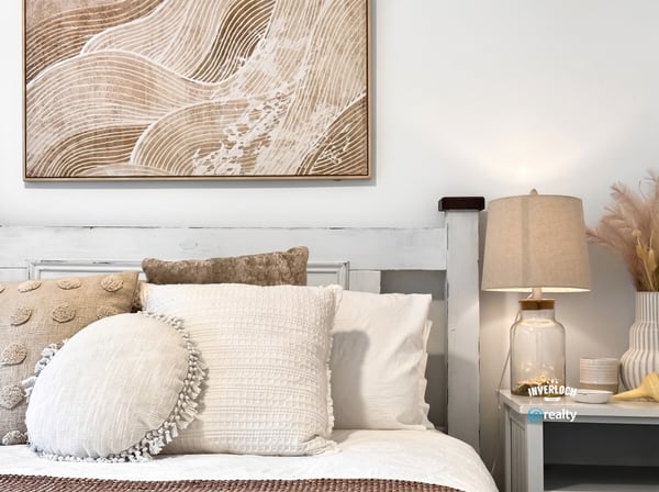 Bright and inviting bedroom featuring textured decor and warm, neutral tones for a cozy atmosphere.