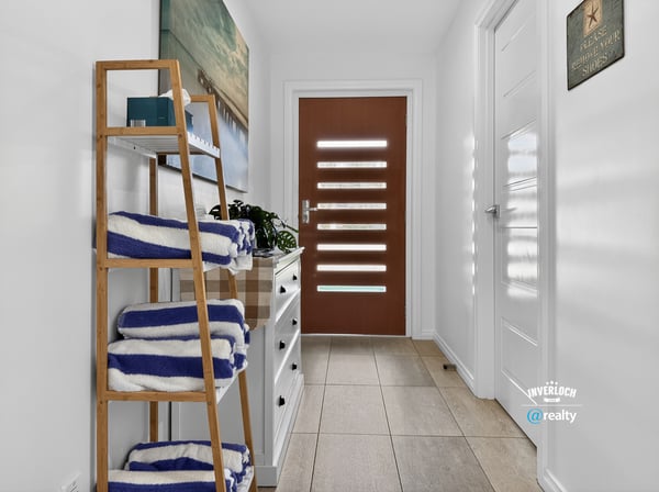 Bright and welcoming entryway featuring modern decor and practical storage solutions for your convenience.