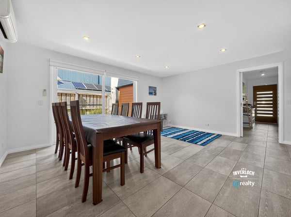 Spacious dining area with abundant natural light, featuring a versatile layout and easy access to outdoor spaces.