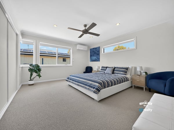 Bright and spacious bedroom featuring large windows, modern amenities, and a comfortable atmosphere for relaxation.