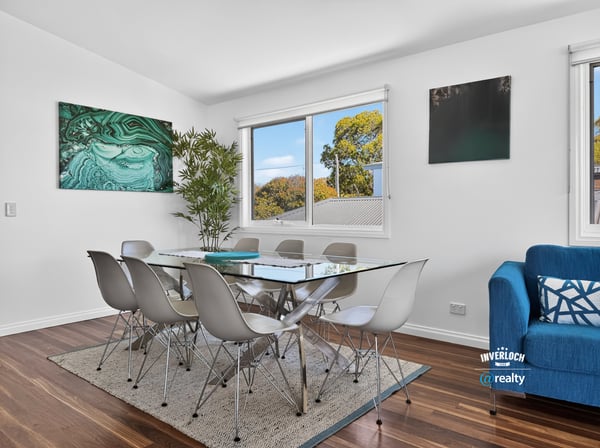 Bright dining area features modern furnishings, large windows, and a contemporary touch, perfect for gatherings.