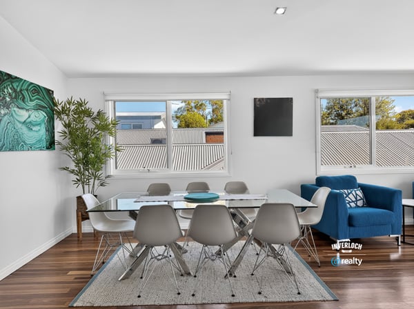 Bright dining area featuring large windows, modern furnishings, and an inviting atmosphere perfect for gatherings.