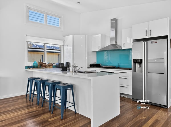 Modern kitchen featuring sleek cabinetry, vibrant backsplash, and functional layout ideal for entertaining.