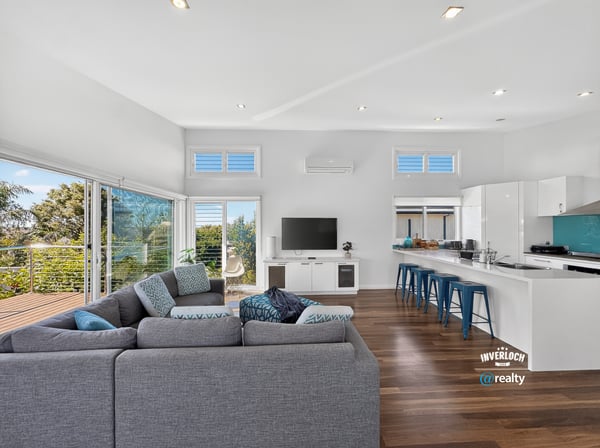 Bright, open-concept living space featuring modern design, large windows, and a seamless flow to outdoor views.