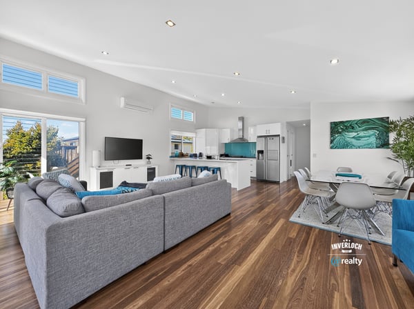Modern open-plan living space with abundant natural light, featuring a spacious kitchen and inviting entertainment area.