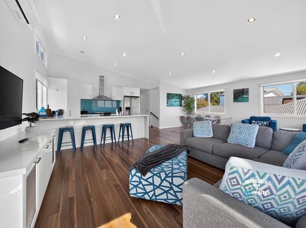Modern open-concept living space with abundant natural light, featuring a sleek kitchen and inviting lounge area.