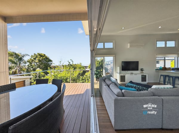 Bright and spacious indoor-outdoor living area with scenic views, perfect for entertaining and relaxation.