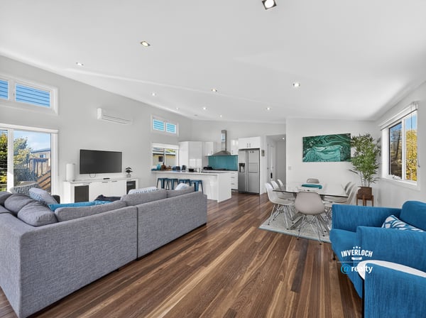 Modern open-concept living space with natural light, sleek design, and inviting atmosphere for family gatherings.