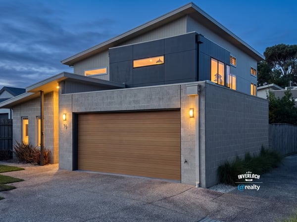 Modern two-story home featuring large windows, contemporary design, and convenient garage access in a vibrant neighborhood.