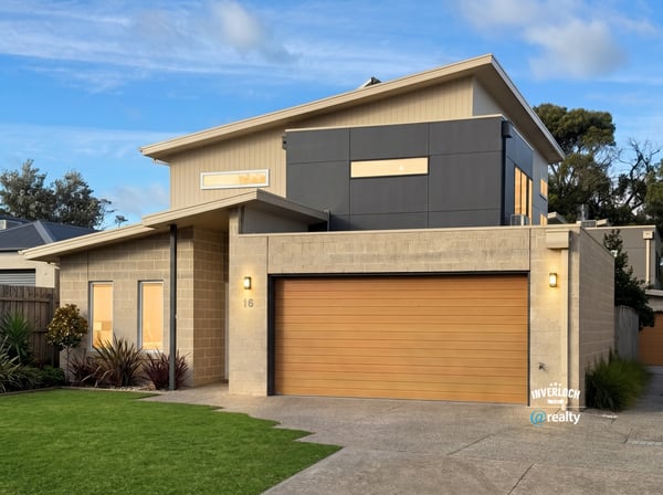 Contemporary home featuring unique architectural design, spacious garage, and vibrant landscaping in a desirable neighborhood.