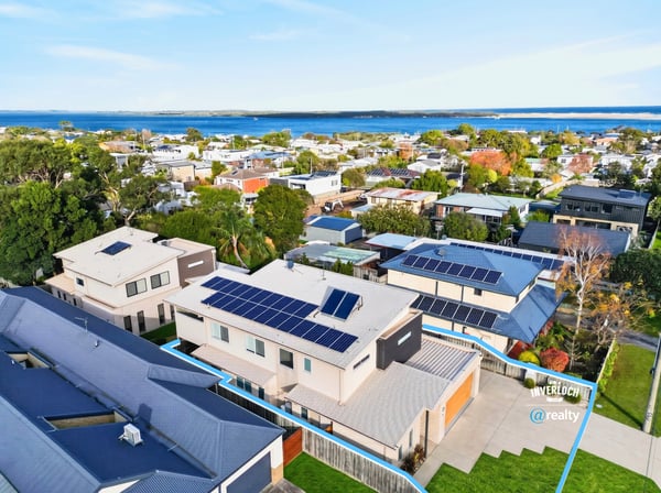 Modern home featuring solar panels and picturesque views, nestled in a vibrant coastal community.