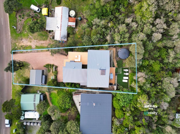Spacious property surrounded by greenery, featuring ample outdoor space and convenient access to main roads.