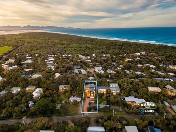 Discover a spacious home surrounded by lush landscapes, just a short stroll from beautiful coastal views.