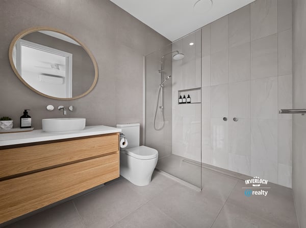 Modern bathroom featuring a spacious walk-in shower, sleek cabinetry, and contemporary finishes throughout.