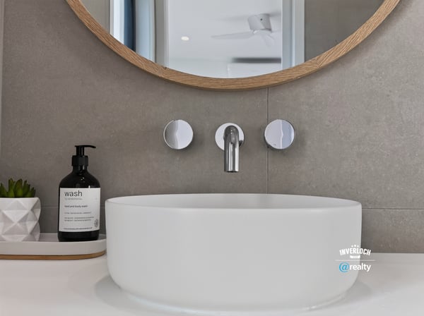 Sleek modern sink with a circular design, complemented by contemporary fixtures and minimalist decor.
