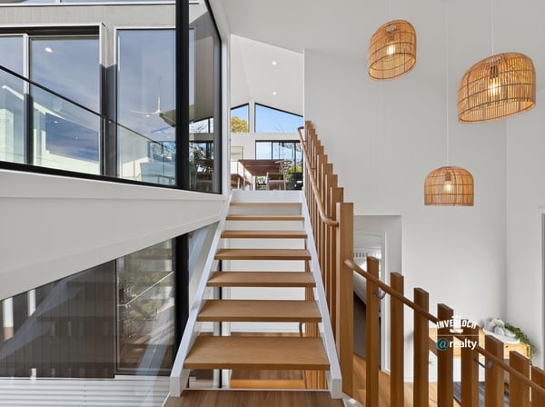 Contemporary design meets natural light in this spacious staircase, highlighting a seamless transition between levels.