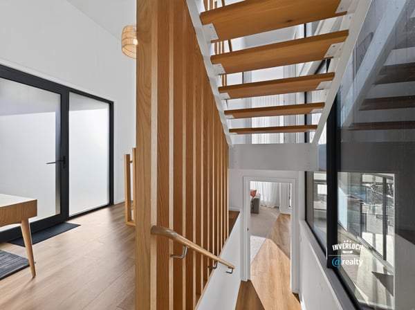 Contemporary open staircase showcases modern design, enhancing the home's inviting and spacious atmosphere.