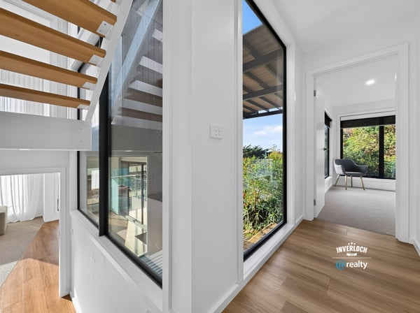 Bright, open hallways lead to inviting spaces with lush outdoor views and modern finishes.