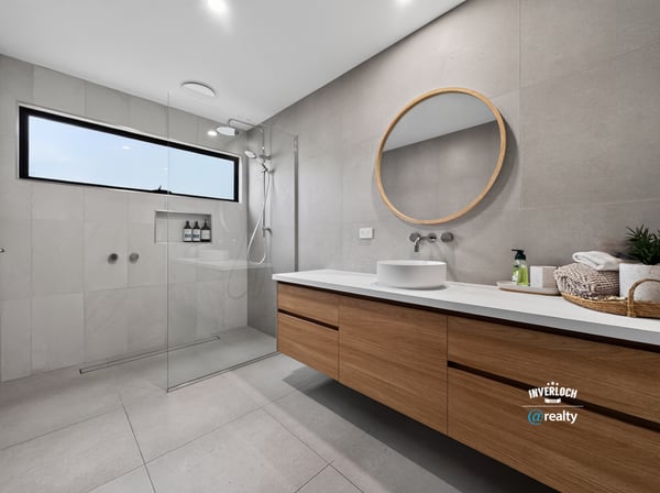 This modern bathroom features a spacious design, sleek finishes, and natural light from a large window.