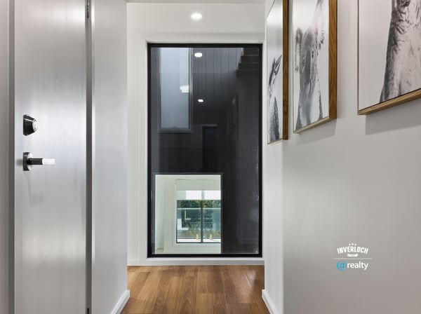 Contemporary hallway featuring sleek design and large windows, creating a bright and welcoming entryway.