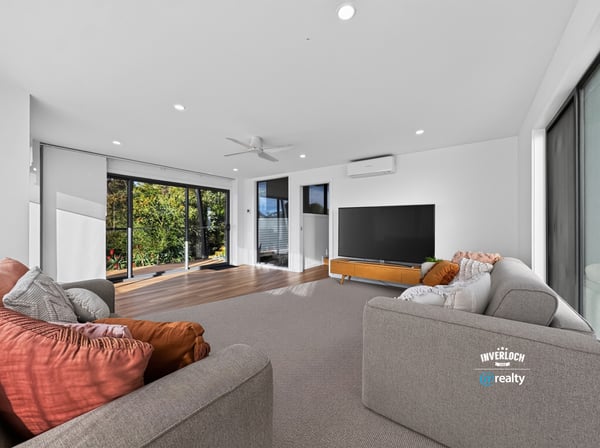 Bright and spacious living area with large windows, offering panoramic views and seamless indoor-outdoor flow.
