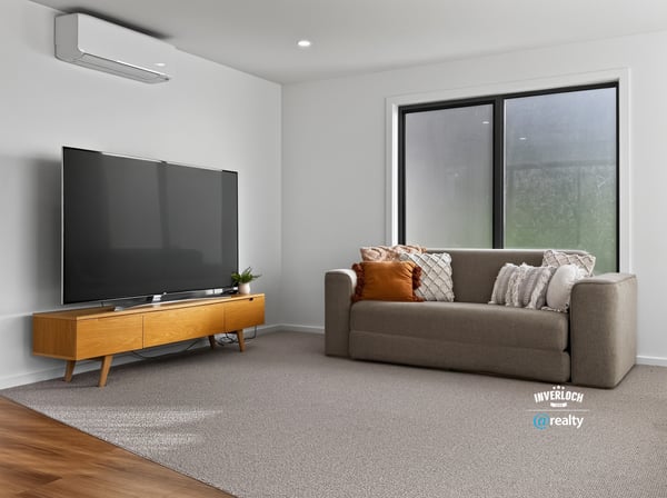 Bright and spacious living area featuring modern furnishings and large windows for ample natural light.