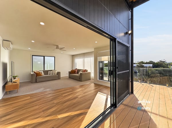 Bright, open living area seamlessly connects to an inviting outdoor deck, perfect for entertaining and relaxation.