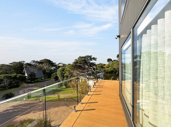 Contemporary outdoor space offers panoramic views, ideal for relaxation or entertaining in a coastal setting.