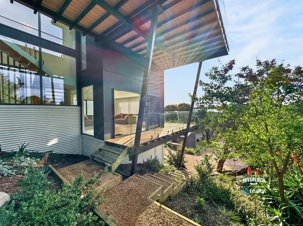 Modern architectural design features expansive outdoor views and vibrant landscaping for a unique living experience.