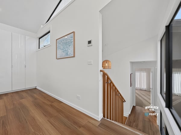 Bright and open foyer with modern design, leading to spacious living areas and stylish staircase.