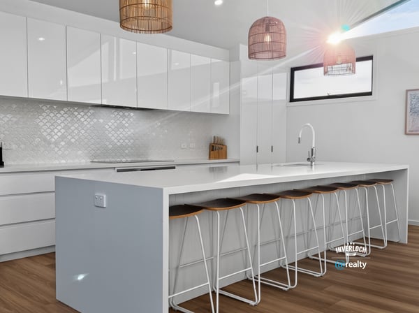 Bright, modern kitchen featuring sleek cabinetry, a spacious island, and inviting seating for social gatherings.