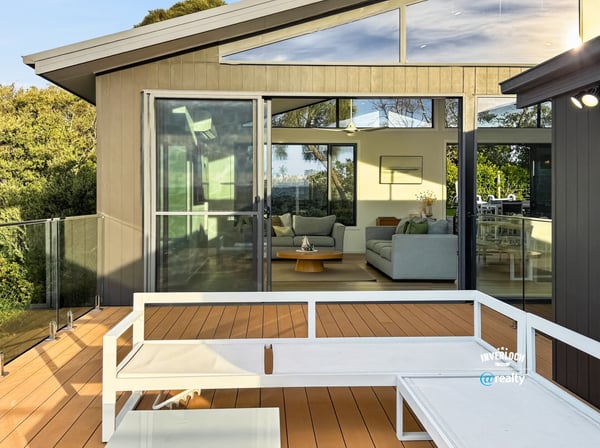 Modern home featuring a spacious deck with expansive views, seamlessly connecting indoor and outdoor living areas.