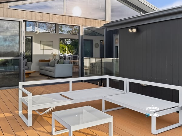 Bright outdoor living space seamlessly connects to an inviting open-plan interior, perfect for entertaining and relaxation.