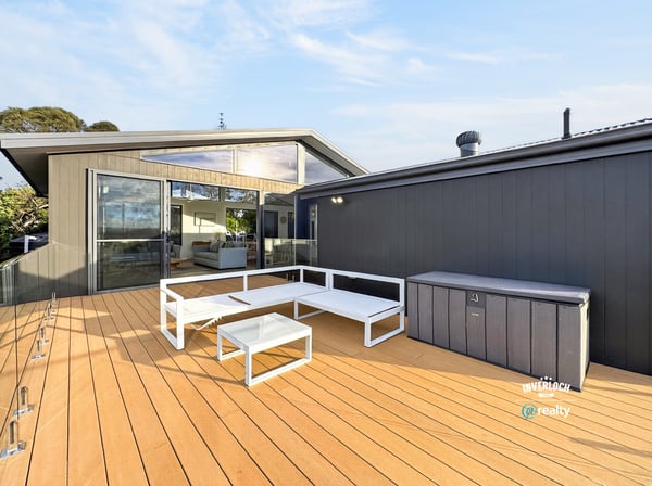Spacious outdoor deck with modern seating, perfect for entertaining and enjoying views in a contemporary setting.