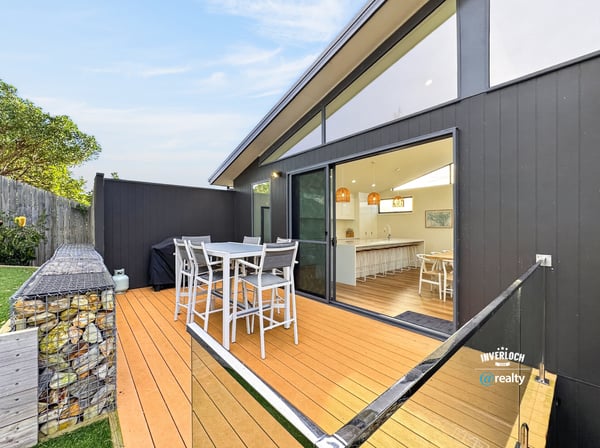 Spacious outdoor deck seamlessly connects to an airy indoor living space, perfect for entertaining and relaxation.