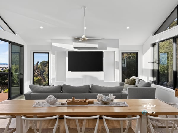Bright, open-plan living area with panoramic views, featuring large windows and a modern, minimalist design.