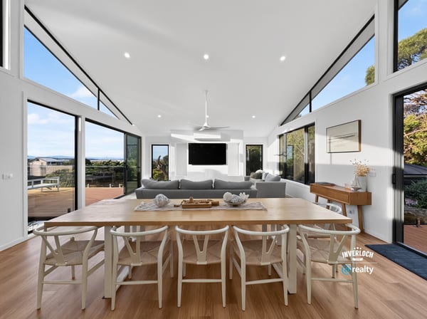 Contemporary open-plan living space featuring abundant natural light and stunning views, ideal for entertaining.