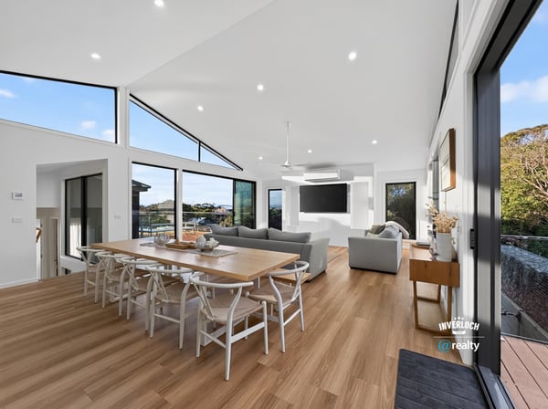 Bright, open living space features large windows, modern design, and seamless connectivity to outdoor views.