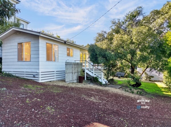 This inviting home features ample natural light, a spacious yard, and a peaceful setting near nature.