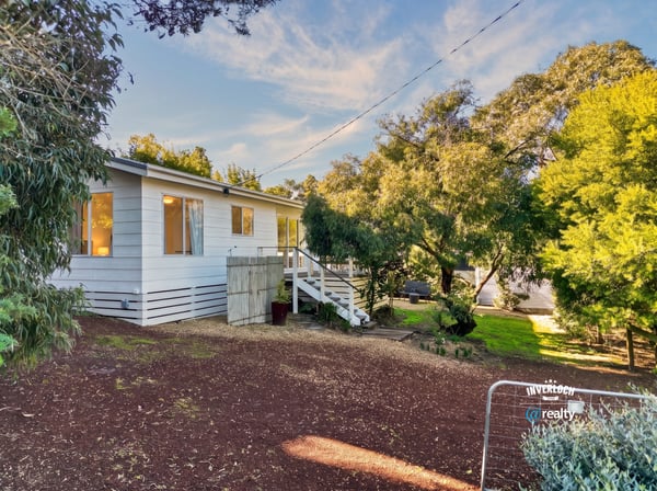 Well-maintained home nestled among lush greenery, featuring ample outdoor space and natural light throughout.