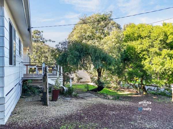 This property features a spacious outdoor area, perfect for relaxation and entertaining amidst lush greenery.